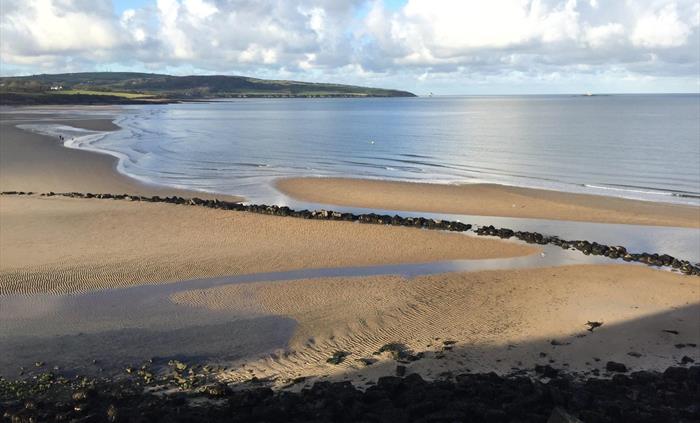 Traeth Lligwy, a beautiful and very popular sandy beach,  flanked by Devonian desert rocks to the north and  Carboniferous rocks (mainly fossiliferous